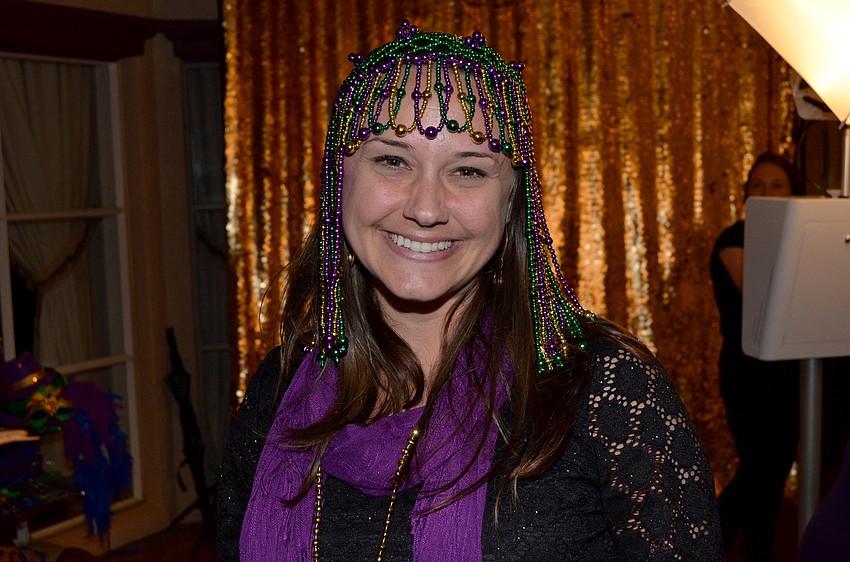 Jamie Jalwan in a festive Mardi Gras headdress at Goodwill Manasotaâ€™s Mardi Gras Gala.