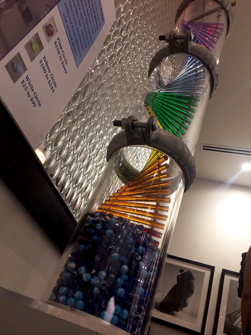 Guests made donations and dropped marbles in Child Protection Centerâ€™s Pillar of Hope at the Blue Ties and Butterflies Pre-Party at Sophieâ€™s at Saks Fifth Avenue Sarasota.