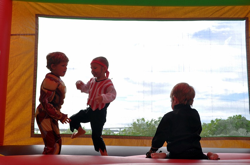 Kids have fun in the jump house.