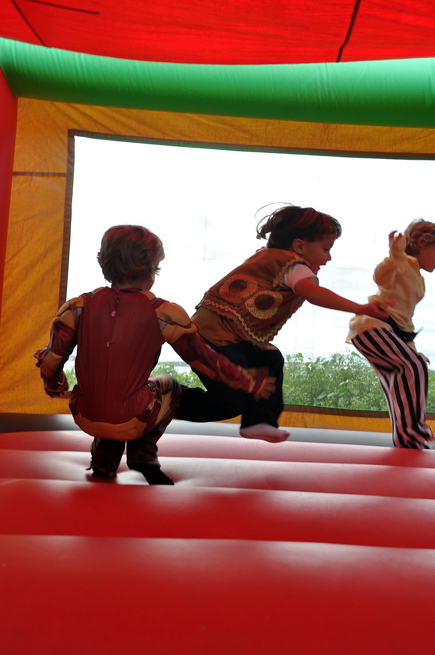 Kids have fun in the jump house.