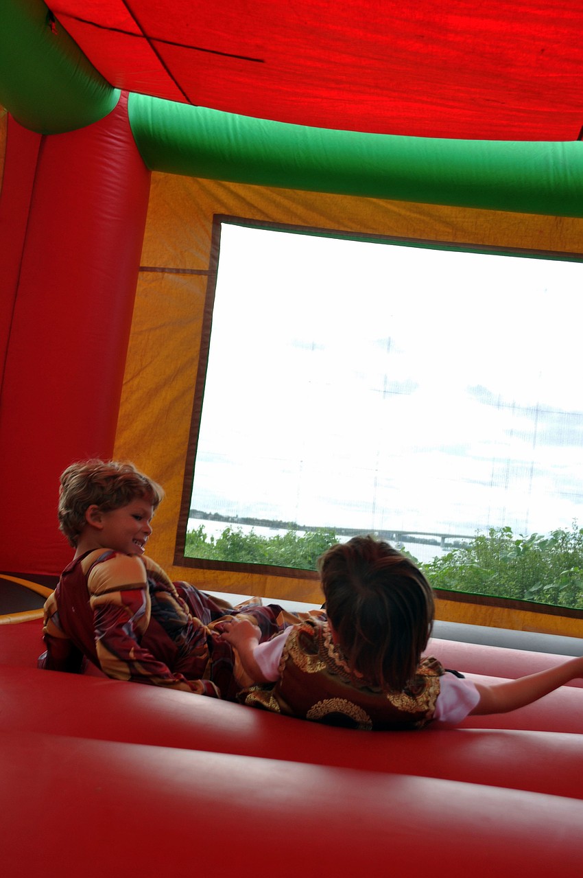 Kids have fun in the jump house.