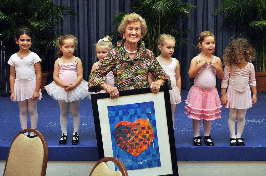 Betty Schoenbaum holds up her gift from the Temple Beth Sholom preschool ballerinaâ€™s after their special performance.