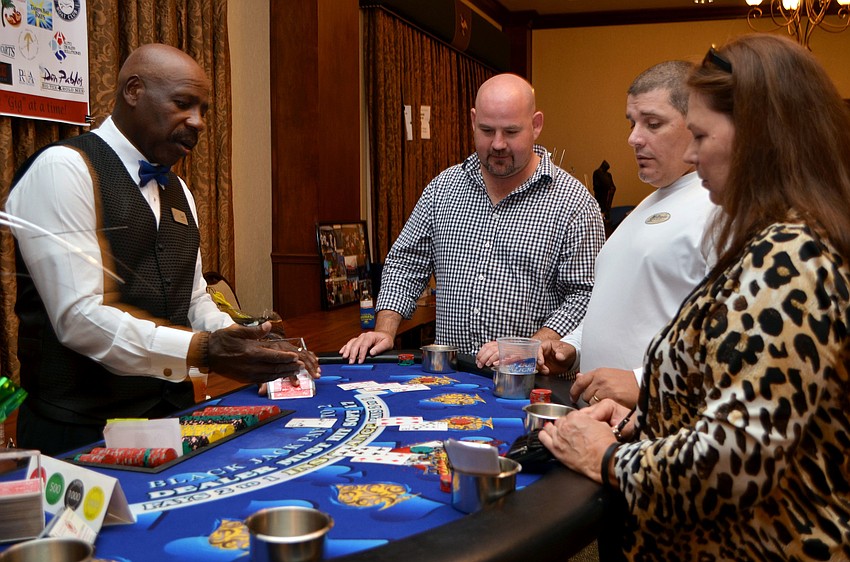 Ryan Oberlin, Bobby Barnes and Margaret Ruppenthal play poker at the 3rd annual All in for â€˜Gigâ€™ event.