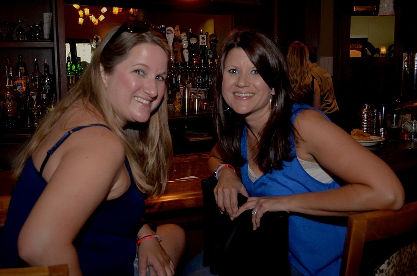 Jill Tezanos and Jennifer Pollard secure spots at the bar to chat with their friends and guest bartenders of the event.