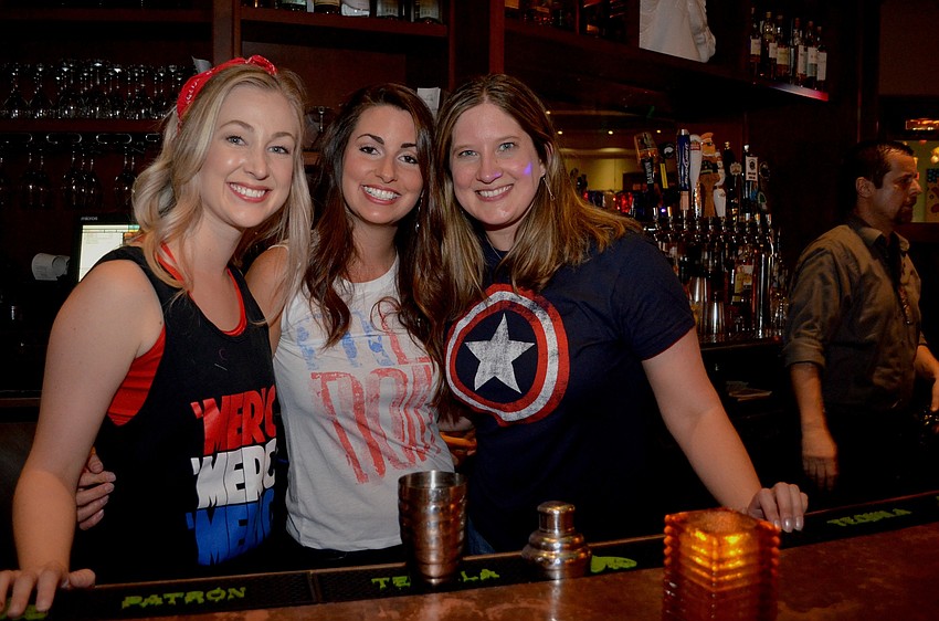 Amanda Smith and Janel Shinn, co-founders of Cheers for Charity, step in to serve up drinks with group member Margi Dawson.