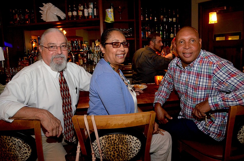 Ed Padilla, Delia Smith and Dennis Turner wait for their cold drinks and hot food.