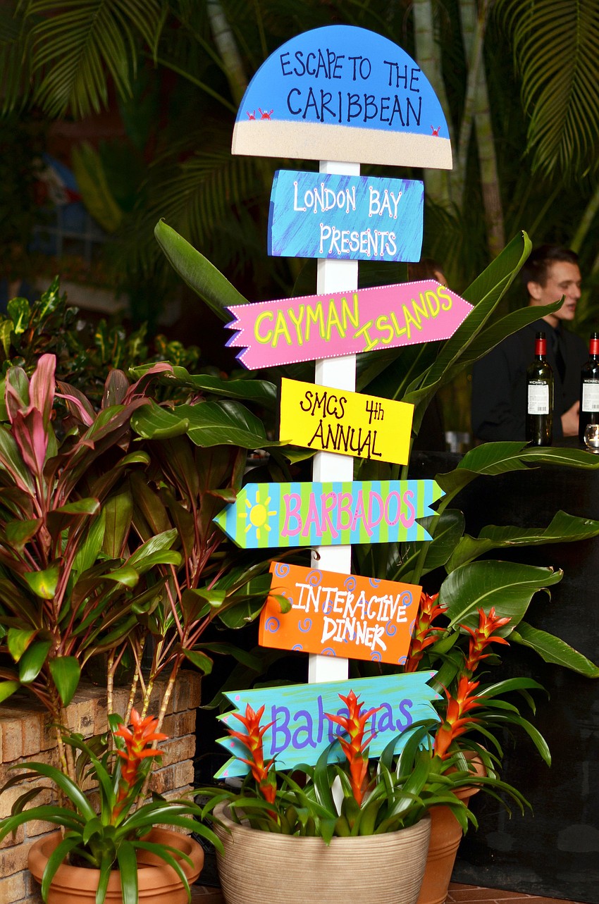 Co-Chairs Courtney Edbrooke and Amanda Lopez painted this coastal sign for the â€˜Escape to the Caribbeanâ€™ Interactive Dinner.