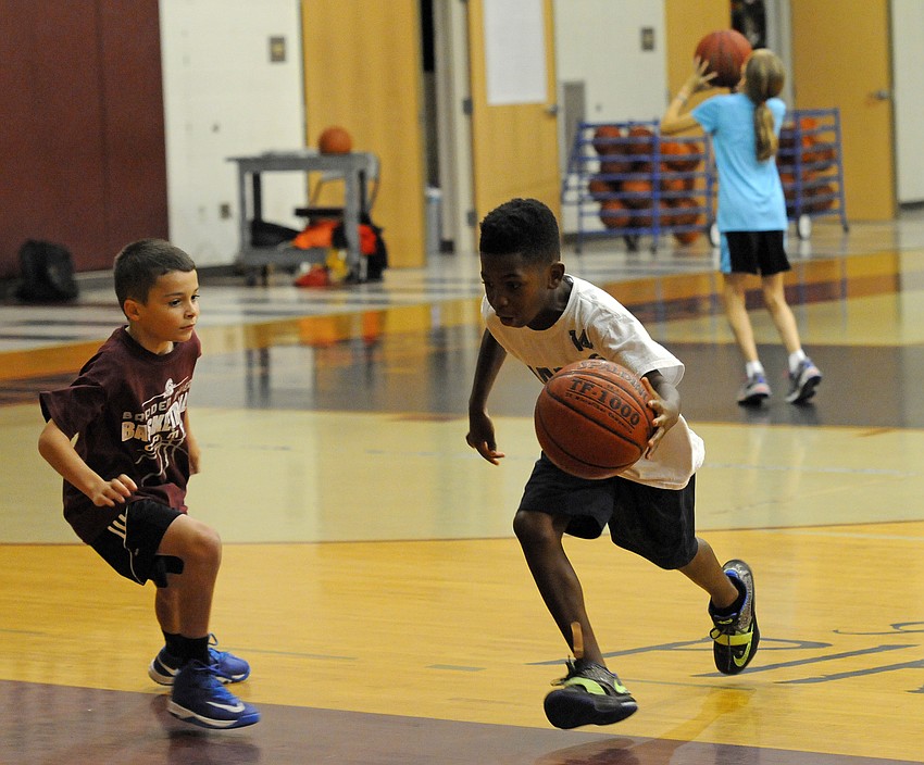 Seven-year-old Nazir Pitchford dribbles to the hoop during a one-on-one competition.