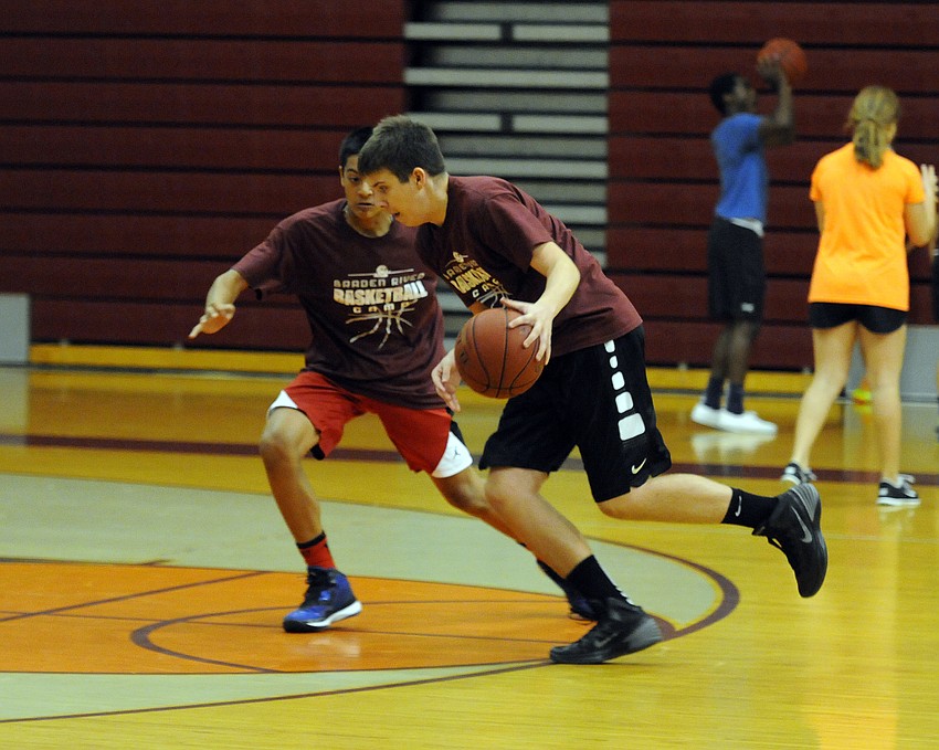 Alex Miller attempts to dribble past Peter Bolas.