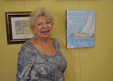 Connie McManus is proud of her painting of a sailboat.