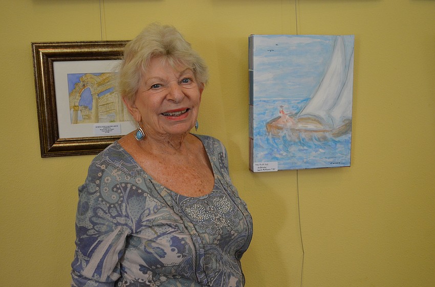 Connie McManus is proud of her painting of a sailboat.