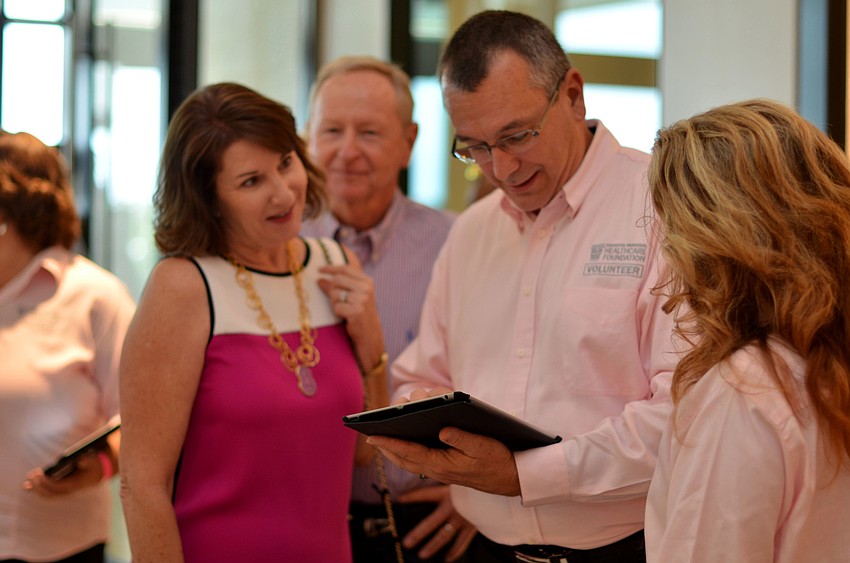 Volunteers help guests sign in at Key to the Cure.
