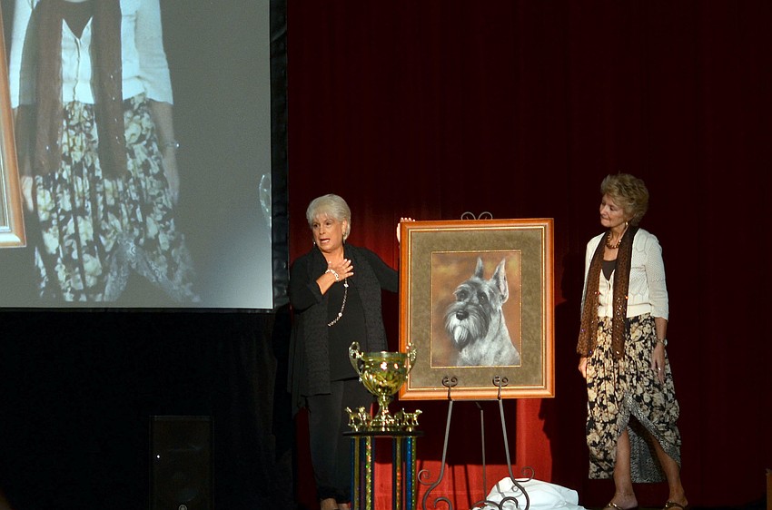 Marsha Panuce receives a painting of her late dog Donte at the 2nd annual Donteâ€™s Den Top Dog 2014.