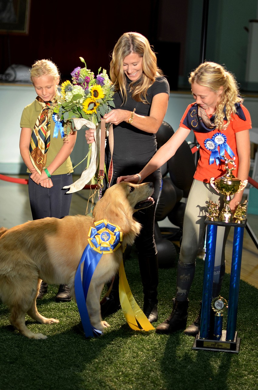 Reagan, Janet and Lucy Walterâ€™s golden retriever, Buck, wins the Donteâ€™s Den Top Dog 2014 Title.