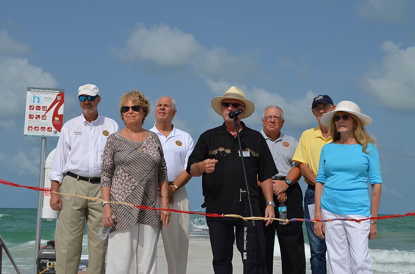 Town Manager Dave Bullock, Commissioner Pat Zunz, Commissioner Irwin Pastor, Mayor Jack Duncan, Vice Mayor Terry Gans, Commissioner Phill Younger and Commissioner Lynn Larson prepare to cut the ribbon Monday.