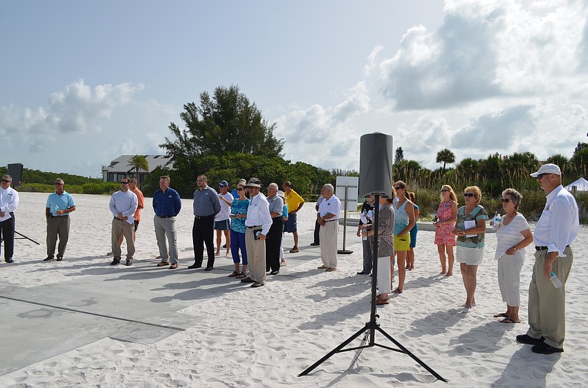 A crowd of local, state and federal officials celebrated a $2.4 million North Shore Road beach access accomplishment Tuesday.