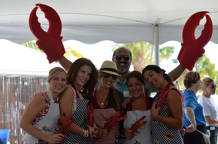 Stephanie Hannum, Renee Phinney, Kristy Cail, Philip Tavill, Debbie Lapinska and Paula Murray get the guests excited for Rockinâ€™ Lobster at the Flip Flops and Fashion luncheon.