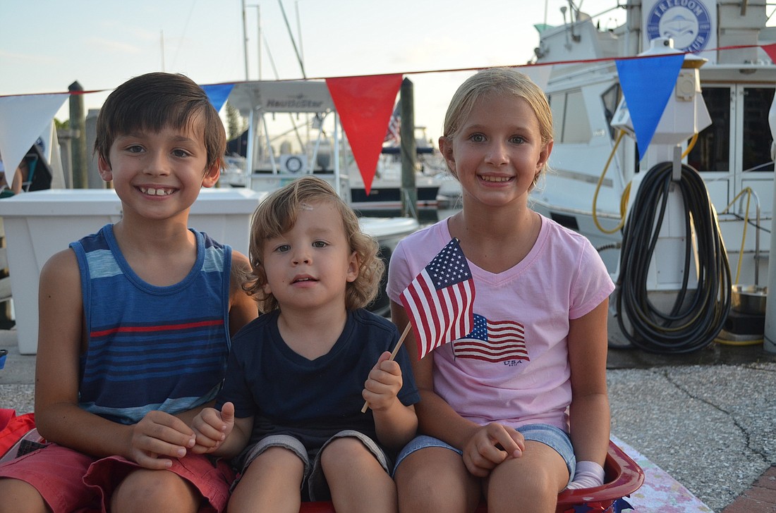 Preston and Greyson Milligan with Kathryn Abend wait for the Downtown Sarasota fireworks show on the bayfront.