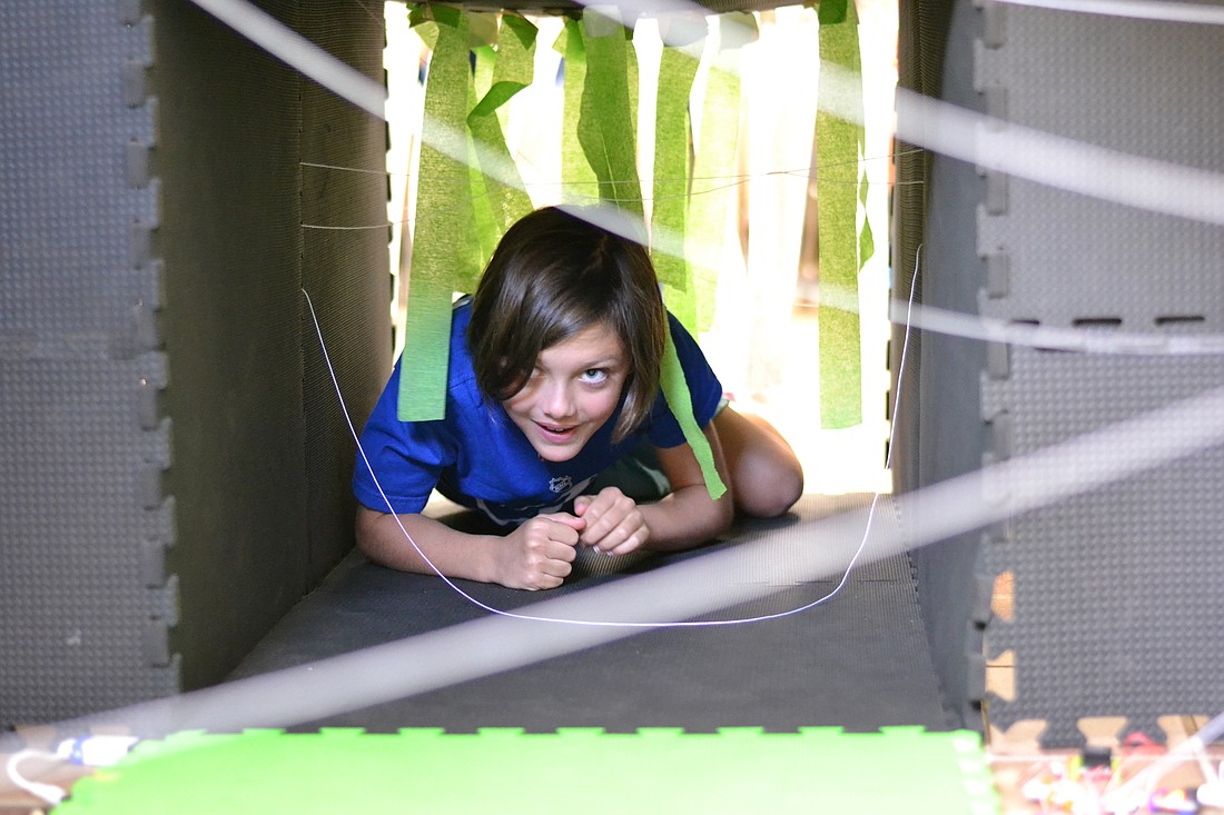 Lauren Van Nostrand crawls through a tunnel for an obstacle course.