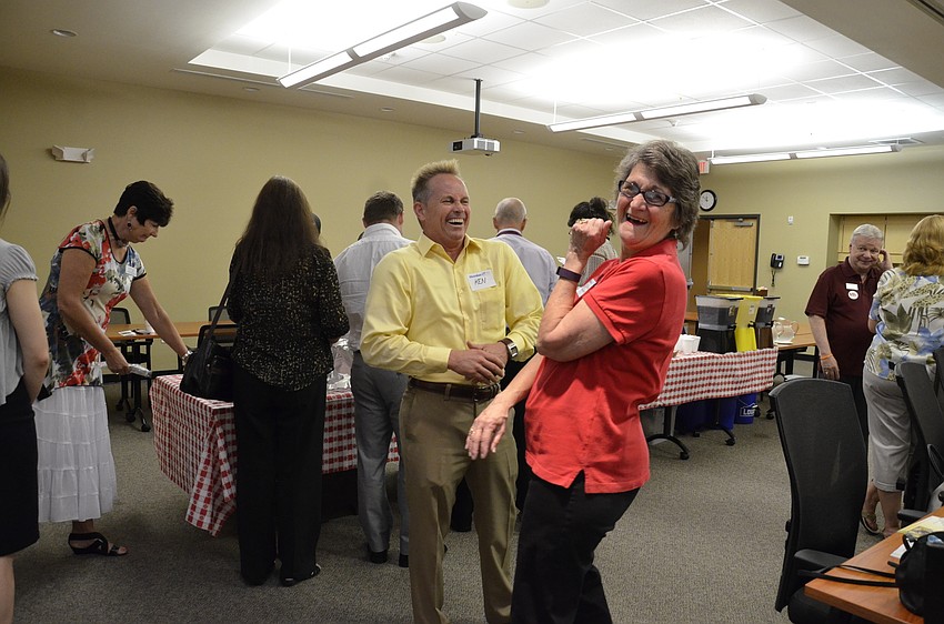 Ken Burke, Hometown News USA, laughs with Carole Zoellner.