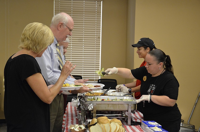 Business owners grab lunch, catered by Sonny's BBQ.