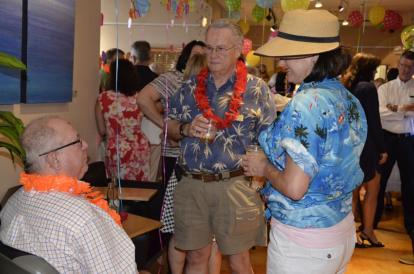 Ken Swan, left, Martin Kane, center, and Patricia McKeithen, right, chat during the networking social.