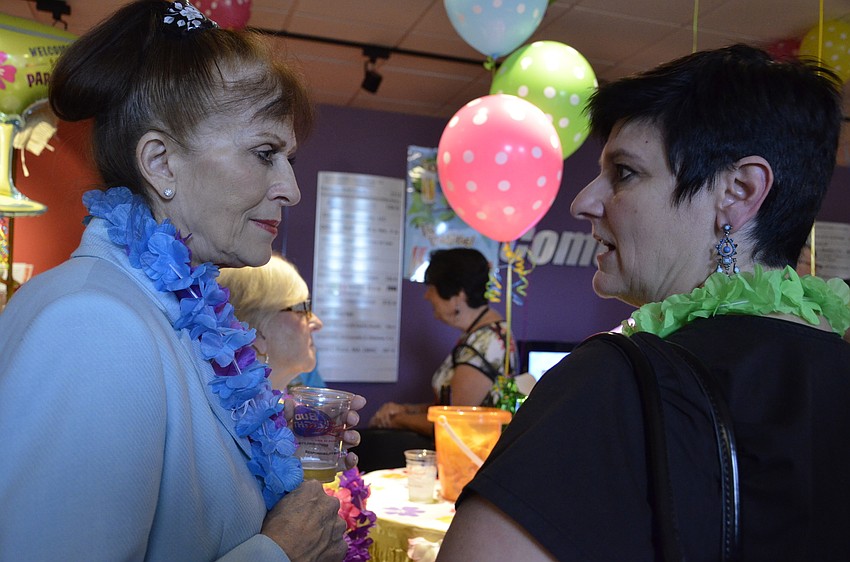 Lea Smith Johnson and Shaun Dumas talk during the social hour of the Alliance networking event.