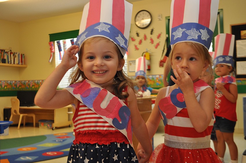 Alexis Gindoff and Summer Sylvester march in the 3-year-old classroom