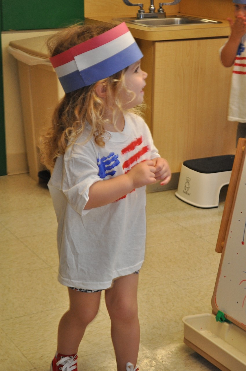 Reese Gilman, 2, looks to her fellow marchers for support.