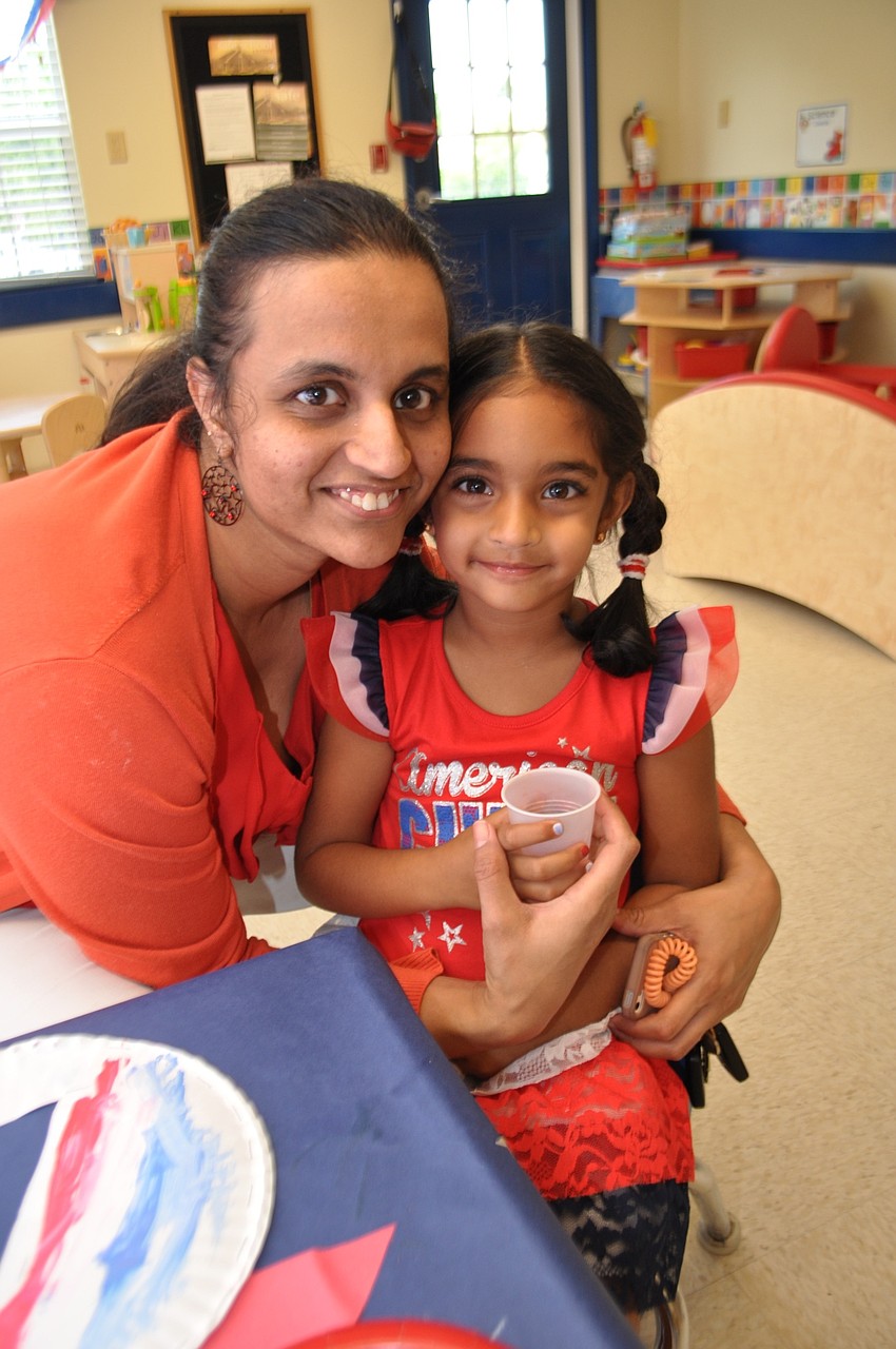Archie Mathura spends time with her daughter, Tanvi, after the parade.