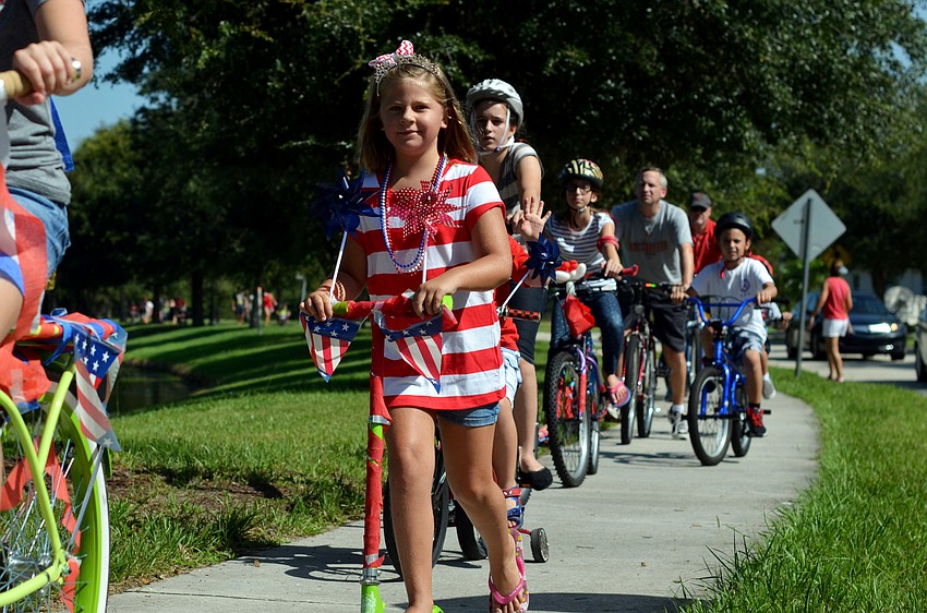 Residents of the GreyHawk Landing Community march down the street in the 4th annual parade.