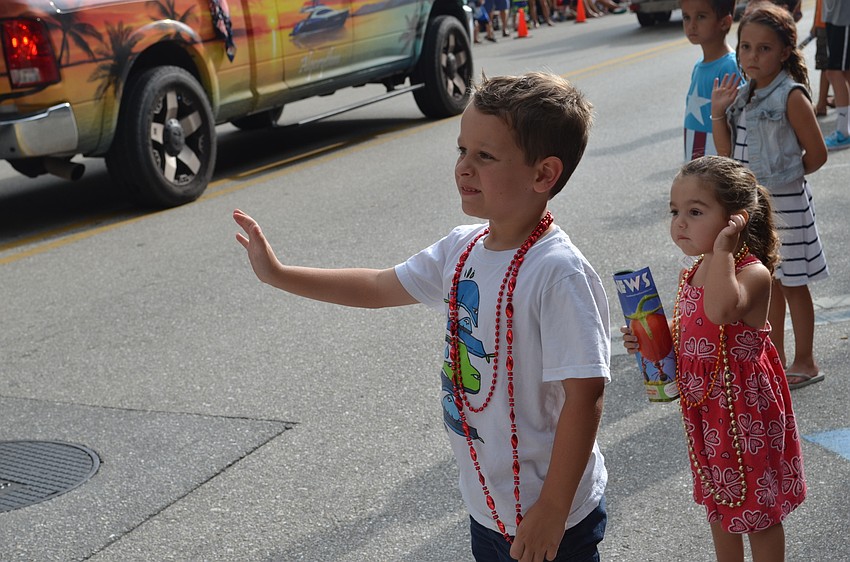 Gavin Peterson waves at participants in the parade.