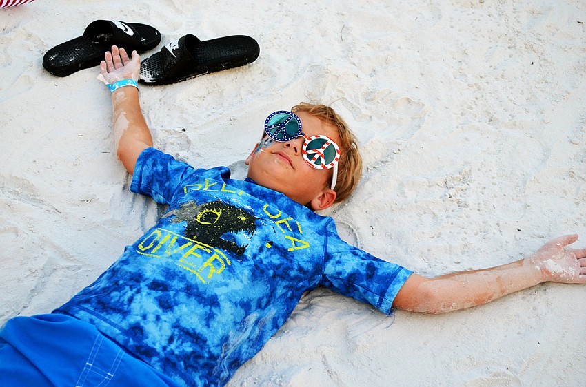 Preston Foster relaxes in the sand while waiting for the Siesta Key Fireworks Show.