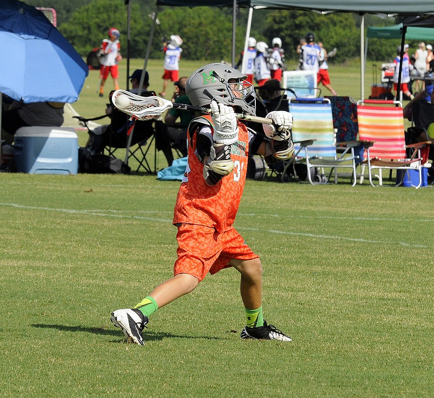 Monsters U11 midfielder Christopher Ferrini passes the ball up to a teammate during pool play June 27.