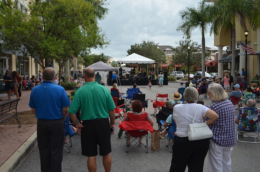 Music and fair lovers enjoying Music on Main despite stormy conditions.