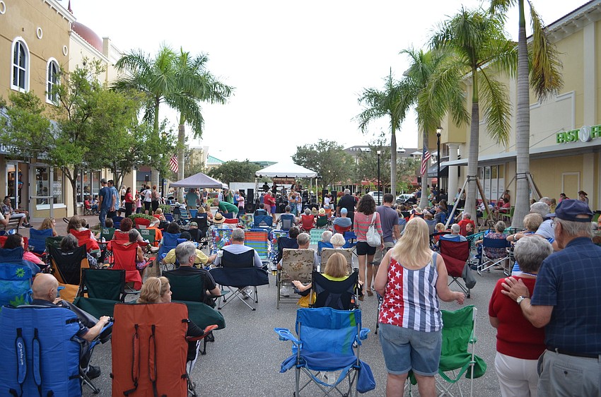 Music and fair lovers enjoying Music on Main despite stormy conditions.