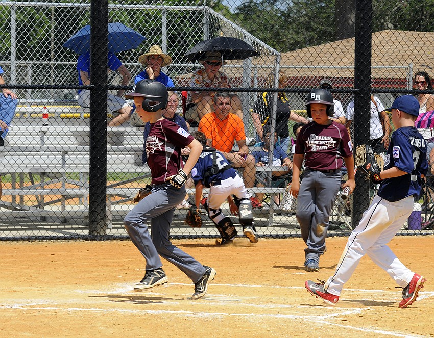 Kyle Vaughn scored a run for the Braden River Little League All-Stars during their game versus Manatee National.