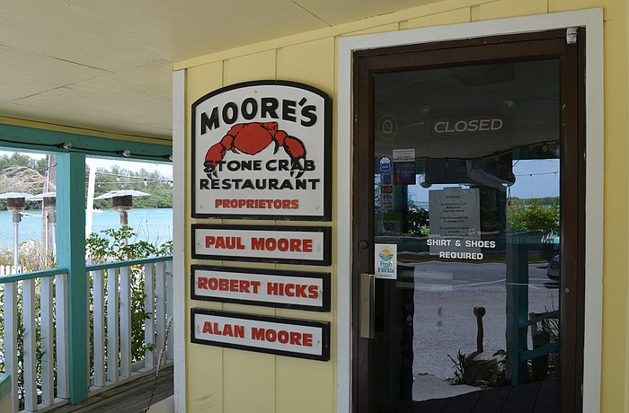 Moore's Stone Crab Restaurant announced its closure Wednesday via signs on the doors Wednesday.