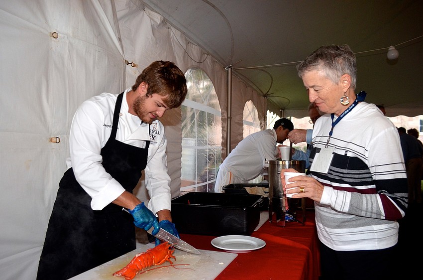 Jaryd Hearn, of Polo Grill and Barâ€™s Fete Ballroom, prepares a lobster for Bobbie Luther-Oâ€™Brien.