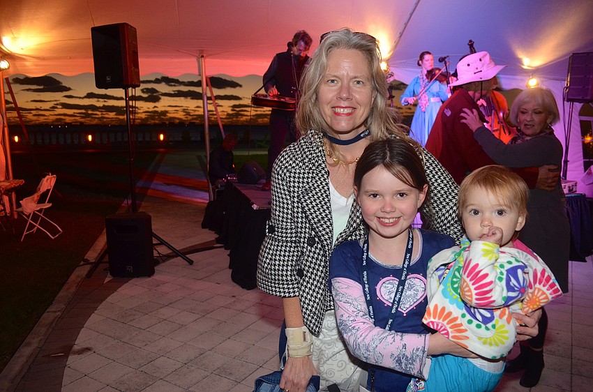 Tricia Hopkins takes a break from dancing with her children, Kate and Caroline.