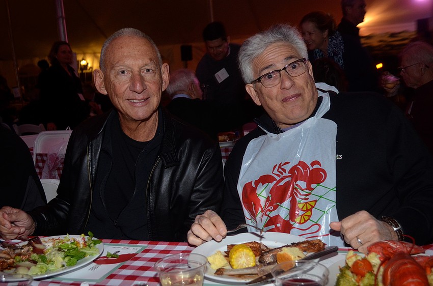 Keith Monda and Steve Rosenfeld enjoy dinner and socializing with friends.