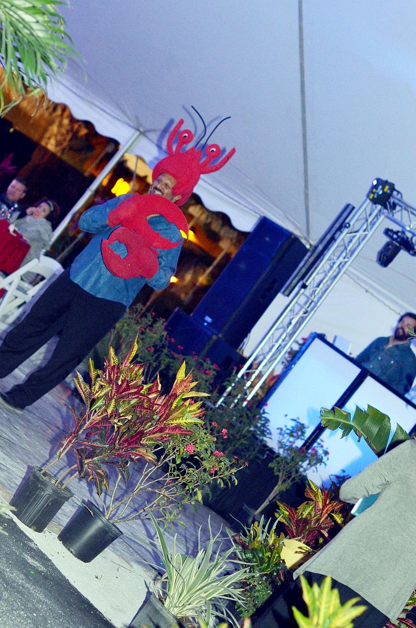 Philip Tavill gets into the lobster costume during the eventâ€™s paddle raise.