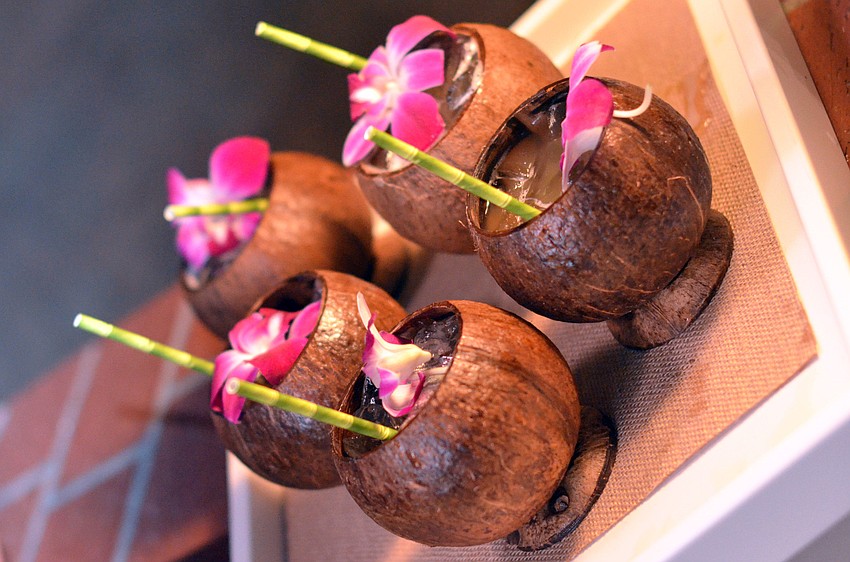 Sticking with the Island Polynesian theme of the evening, guests enjoyed Navy Grogs, a mixture of light, dark and demerara rums, in an island coconut.