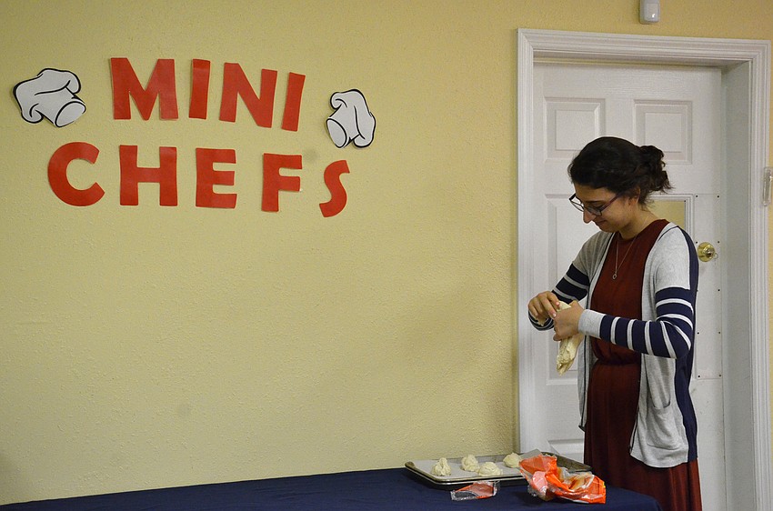 Counselor Ceita Marasow gets the bread dough ready for Gan Israel campers.