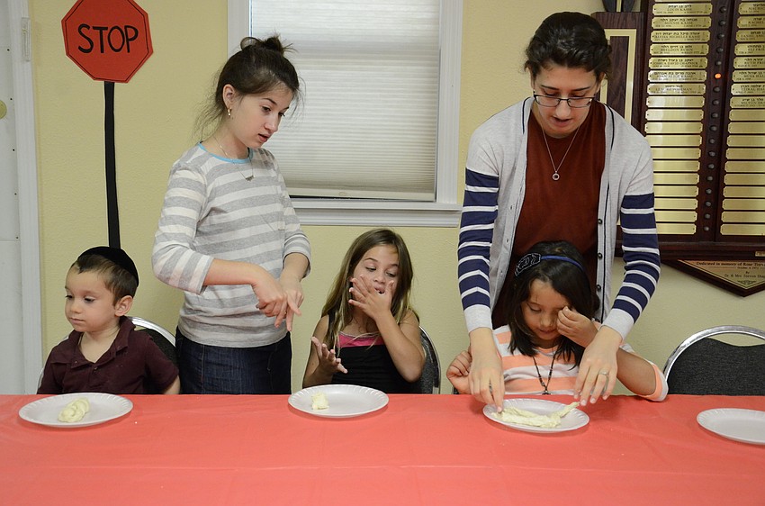 Shua Bukiet, Zoe Korman and Chaya Steckel get help from counselors Rivkah Kessler and Ceita Marasow.