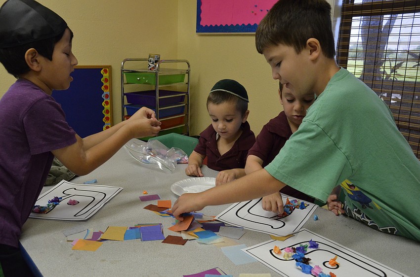 Gan Israel campers decorate alphabet letters.