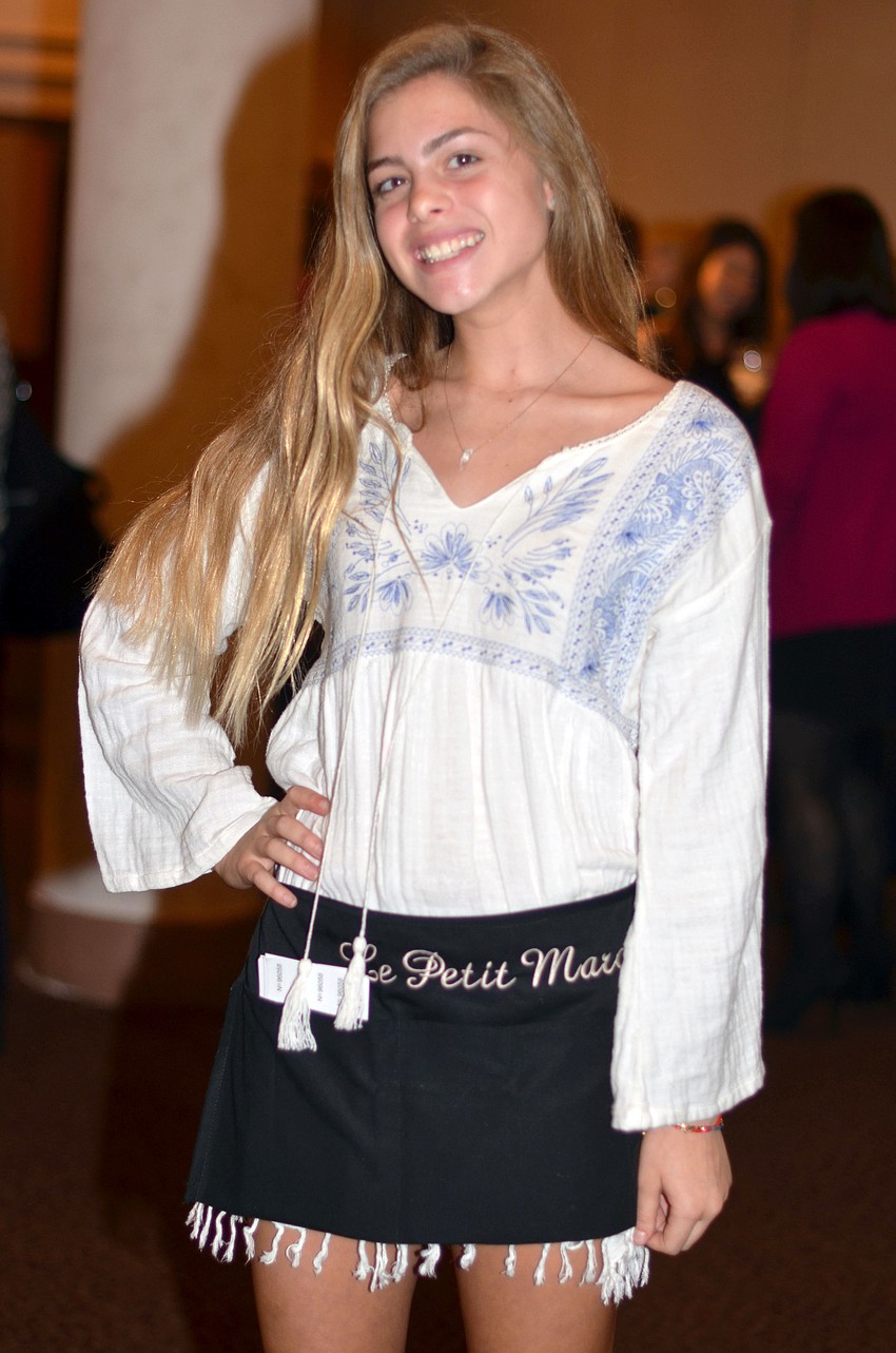 Madisyn Opstal sells raffle tickets at Le Petit Marche.