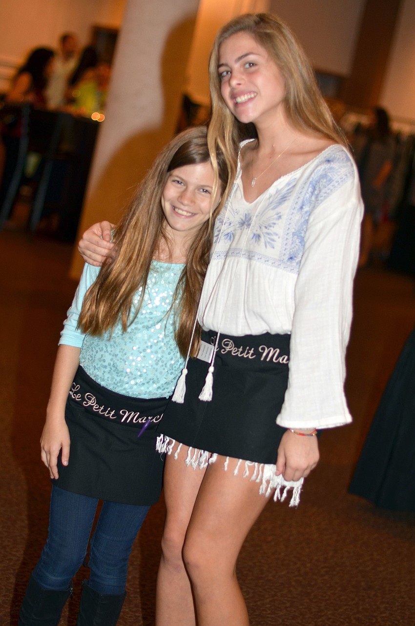 Jordyn Saltzberg and Madisyn Opstal sell raffle tickets at Le Petit Marche.