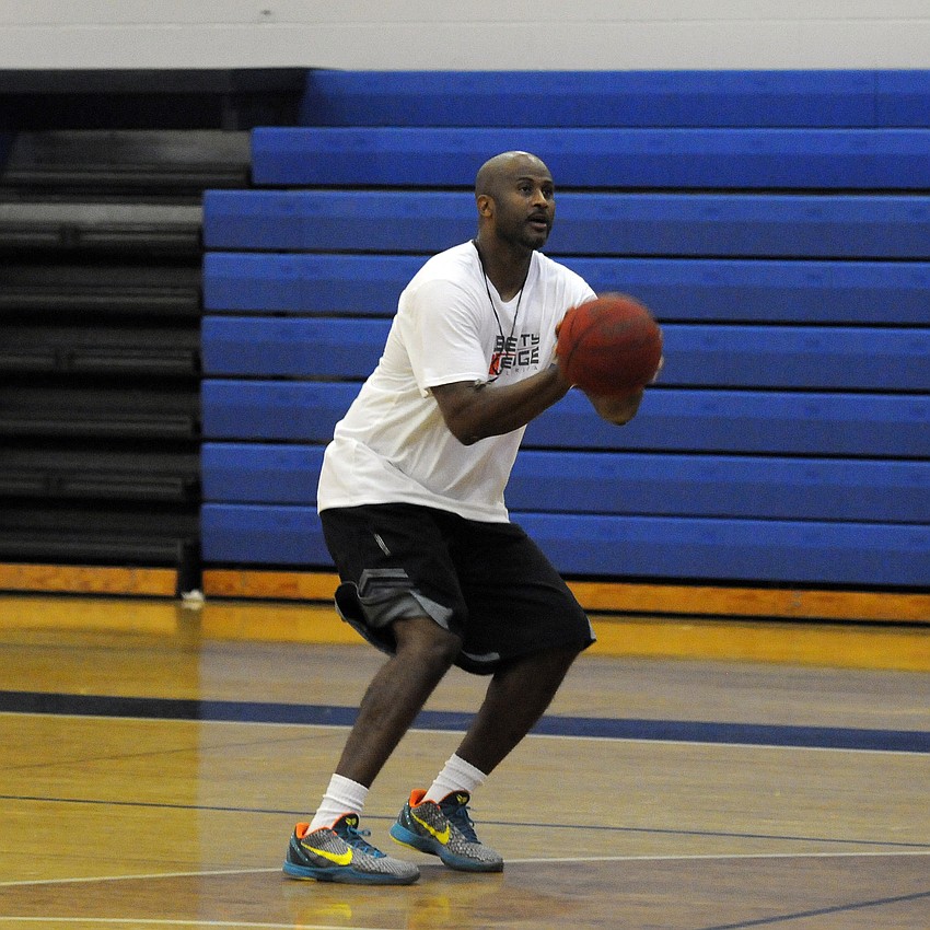 Former NBA player and ODA basketball coach Marcus Liberty demonstrates a shooting drill.