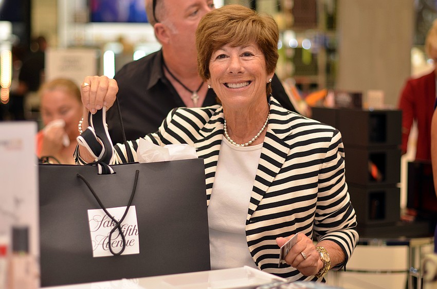 Paula Stein buys cosmetics at Saks Fifth Avenue during the Brushes with Greatness event.